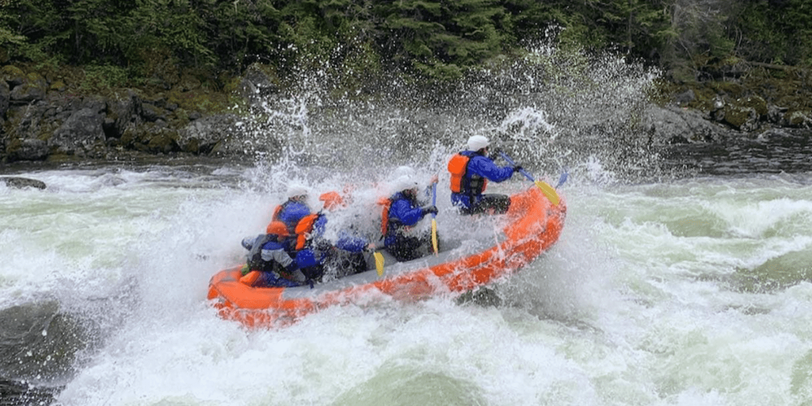 Exciting whitewater rafting on the Lochsa River with Zoo Town Surfers. Rafters in vibrant safety gear navigate through intense rapids, with water splashing dramatically around them. The lush forest in the background highlights the adventure and beauty of the rafting experience.